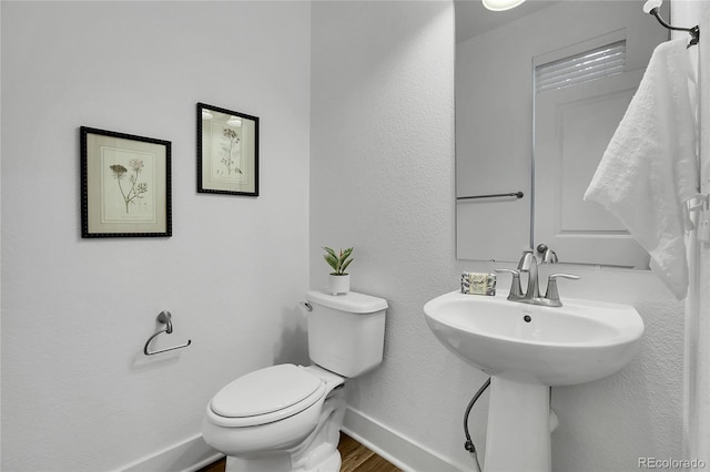 8458 Parkland St, Broomfield, CO 80021 - half bath featuring toilet and wood finished floors