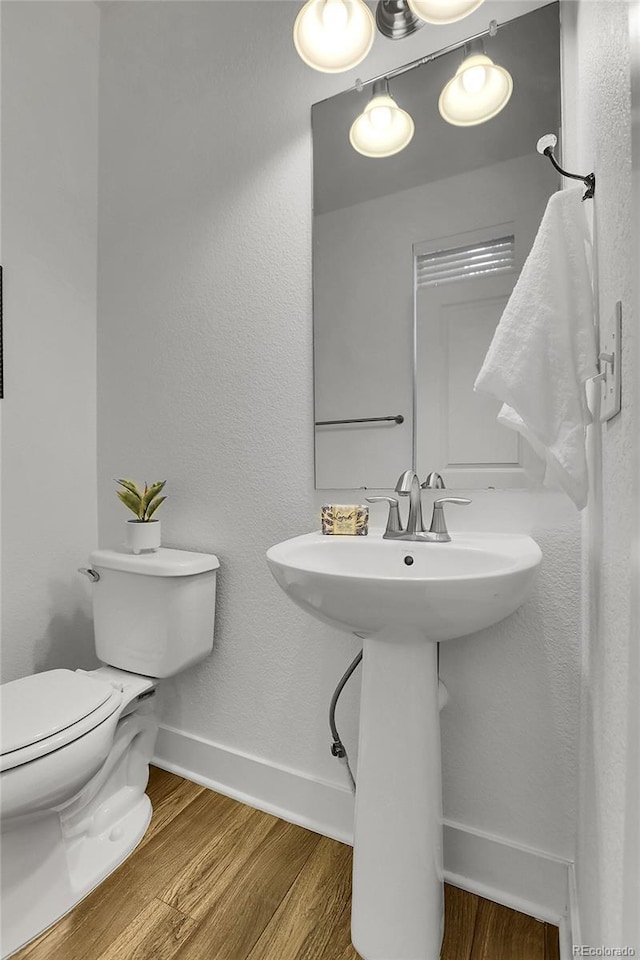 8458 Parkland St, Broomfield, CO 80021 - half bathroom with wood finished floors and toilet