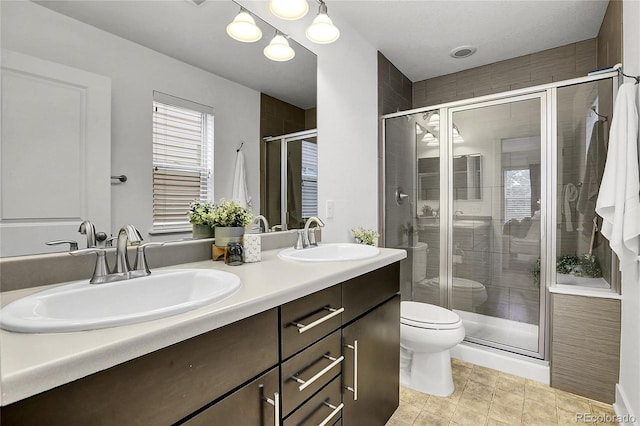 8458 Parkland St, Broomfield, CO 80021 - bathroom featuring double vanity and a shower stall
