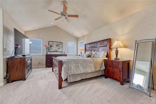 carpeted bedroom featuring lofted ceiling, a textured ceiling, and ceiling fan