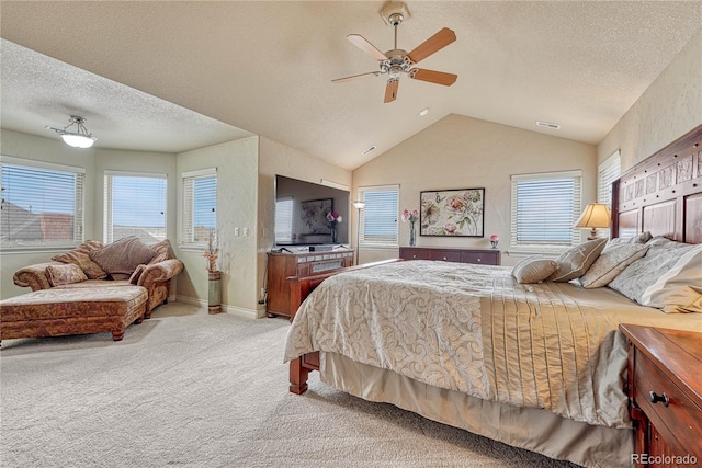 carpeted bedroom featuring multiple windows, vaulted ceiling, ceiling fan, and a textured ceiling