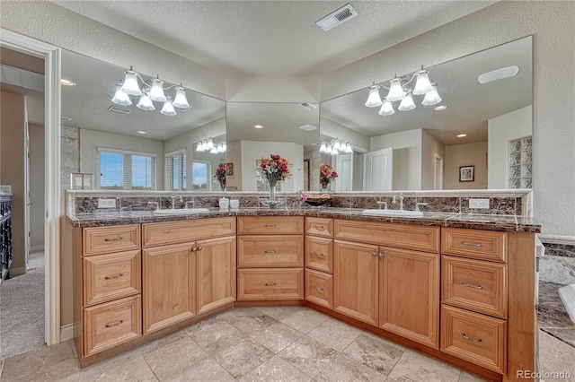 bathroom with vanity and a textured ceiling