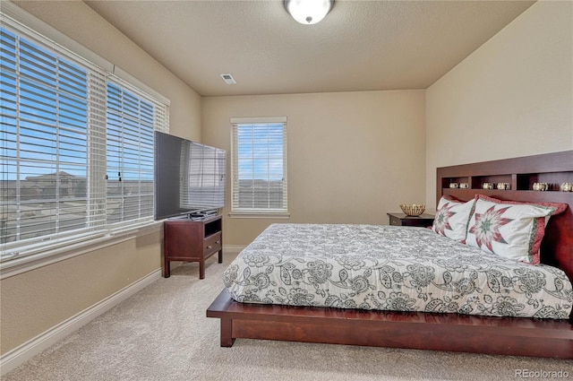 bedroom featuring carpet and a textured ceiling