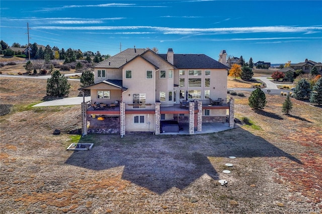 rear view of property featuring a patio