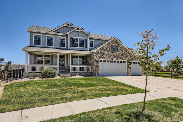 22197 E Stroll Ave, Parker, CO 80138 - craftsman-style house featuring board and batten siding, a porch, an attached garage, driveway, and stone siding