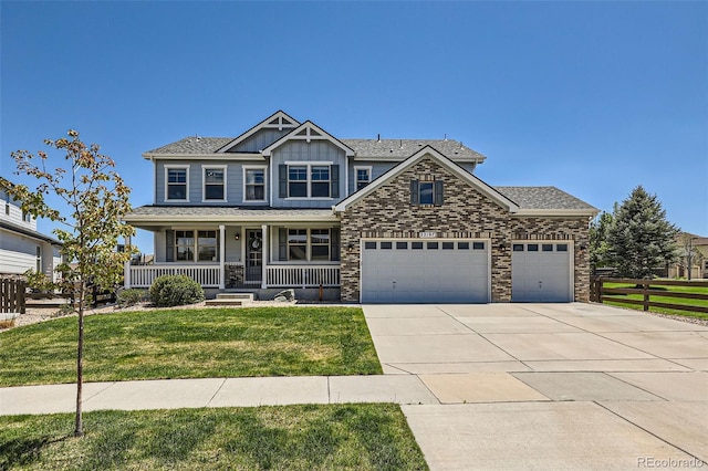 22197 E Stroll Ave, Parker, CO 80138 - craftsman house with covered porch, an attached garage, driveway, board and batten siding, and stone siding