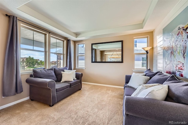 22197 E Stroll Ave, Parker, CO 80138 - living area with a tray ceiling, light colored carpet, and baseboards