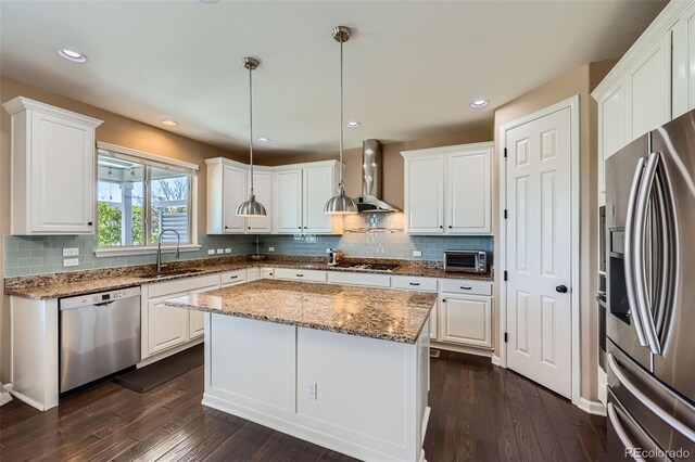 22197 E Stroll Ave, Parker, CO 80138 - kitchen featuring appliances with stainless steel finishes, a sink, wall chimney range hood, dark wood-type flooring, and white cabinets