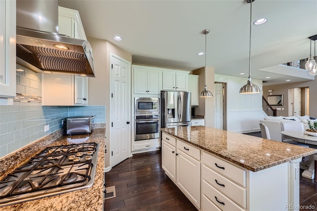 22197 E Stroll Ave, Parker, CO 80138 - kitchen featuring appliances with stainless steel finishes, island range hood, light stone countertops, dark wood-style flooring, and decorative backsplash