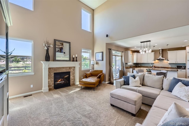 22197 E Stroll Ave, Parker, CO 80138 - living room with plenty of natural light, a tile fireplace, a towering ceiling, light carpet, and baseboards