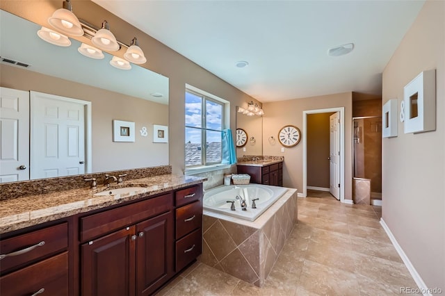 22197 E Stroll Ave, Parker, CO 80138 - bathroom featuring a shower stall, a garden tub, and two vanities