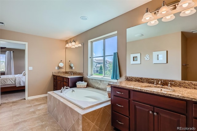22197 E Stroll Ave, Parker, CO 80138 - ensuite bathroom with a garden tub, two vanities, and tile patterned flooring