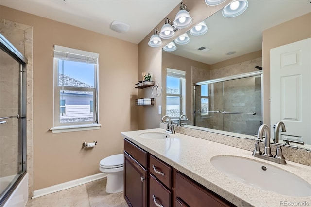 22197 E Stroll Ave, Parker, CO 80138 - full bathroom with baseboards, double vanity, toilet, tile patterned floors, and combined bath / shower with glass door