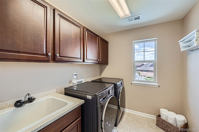 22197 E Stroll Ave, Parker, CO 80138 - clothes washing area featuring washer and dryer, cabinet space, baseboards, and light tile patterned floors