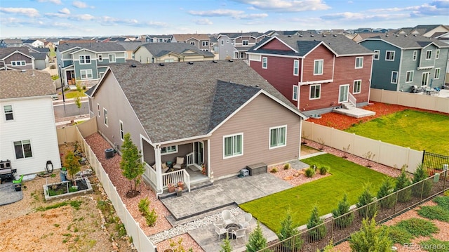 13138 Stoney Meadows Way, Peyton, CO 80831 - rear view of property featuring a residential view, a vegetable garden, a patio, a shingled roof, and a fenced backyard