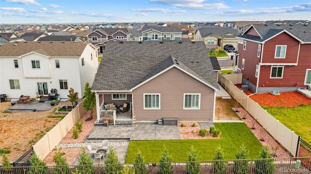 13138 Stoney Meadows Way, Peyton, CO 80831 - back of property featuring a residential view, a patio, a fenced backyard, and roof with shingles
