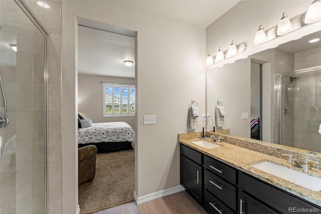 13138 Stoney Meadows Way, Peyton, CO 80831 - ensuite bathroom featuring wood finished floors, double vanity, and a shower stall