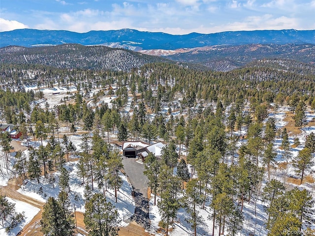 aerial view with a mountain view and a forest view