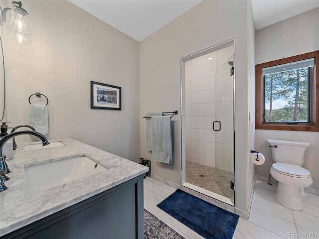 full bath featuring a shower stall, toilet, double vanity, and a sink