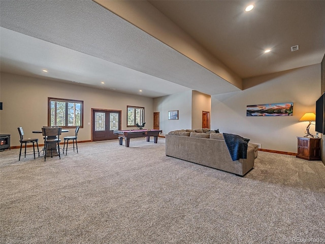 carpeted living area with recessed lighting, visible vents, baseboards, and french doors