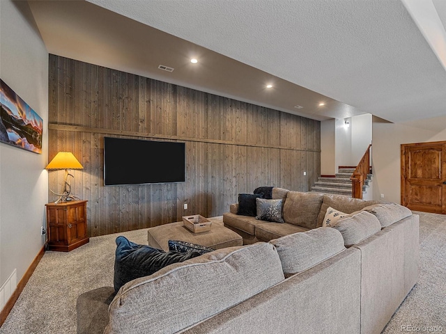 living area with visible vents, wood walls, stairs, carpet floors, and recessed lighting