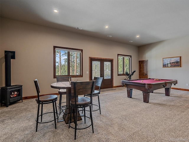 rec room with visible vents, light carpet, recessed lighting, french doors, and a wood stove