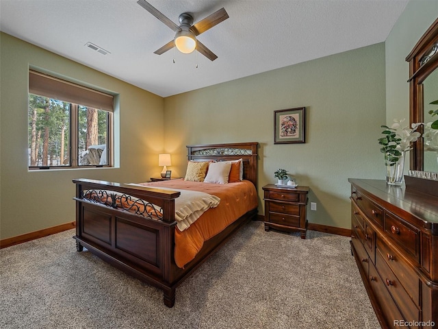 bedroom featuring baseboards, visible vents, carpet floors, and ceiling fan