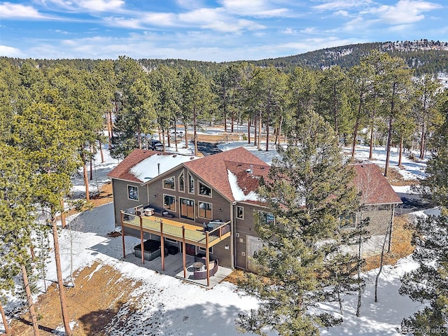 snowy aerial view with a forest view