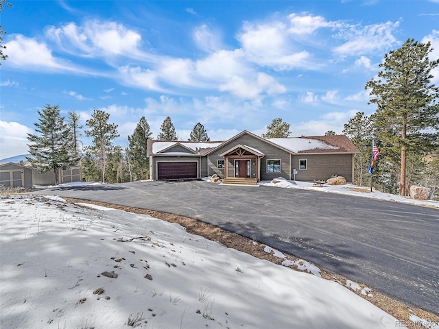 view of front of home featuring aphalt driveway and an attached garage