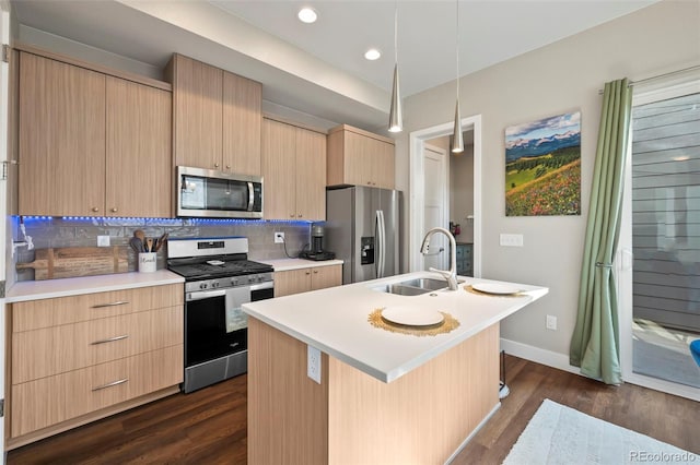 kitchen with stainless steel appliances, a sink, light countertops, decorative backsplash, and light brown cabinetry