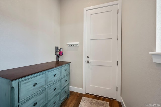 doorway to outside featuring dark wood finished floors and baseboards