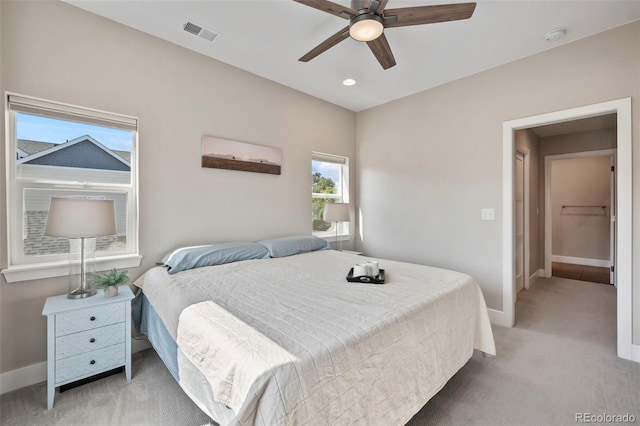 bedroom with baseboards, visible vents, a ceiling fan, light colored carpet, and recessed lighting