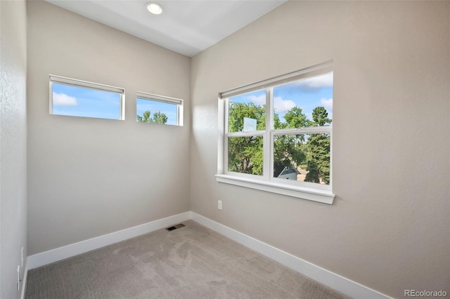 spare room with recessed lighting, baseboards, visible vents, and light colored carpet