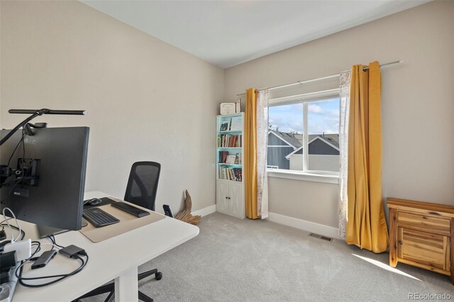 home office with carpet floors, baseboards, and visible vents