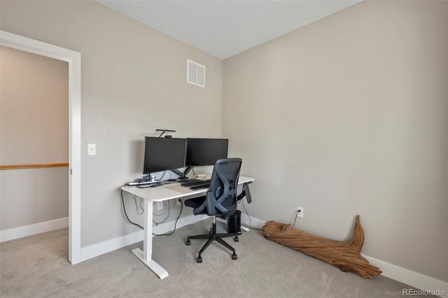 carpeted office space with visible vents and baseboards