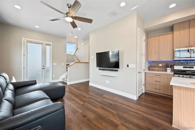 living room featuring recessed lighting, dark wood-style flooring, and baseboards