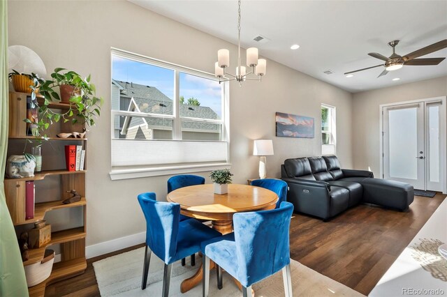 dining room featuring ceiling fan with notable chandelier, baseboards, wood finished floors, and recessed lighting