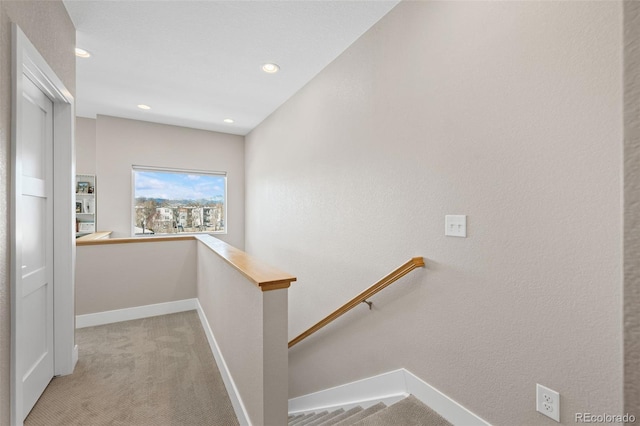 corridor featuring recessed lighting, carpet, an upstairs landing, and baseboards