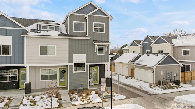 multi unit property with board and batten siding, fence, a garage, and central air condition unit