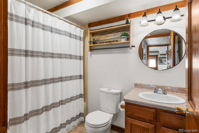 bathroom featuring toilet, vanity, and curtained shower