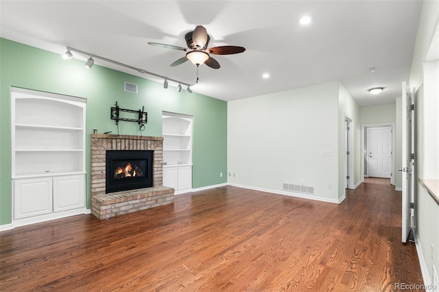 9365 Erminedale Dr, Lone Tree, CO 80124 - unfurnished living room featuring track lighting, a ceiling fan, built in features, a brick fireplace, and recessed lighting