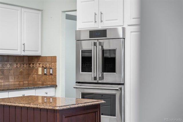9365 Erminedale Dr, Lone Tree, CO 80124 - kitchen with stainless steel double oven, stone countertops, decorative backsplash, and white cabinets