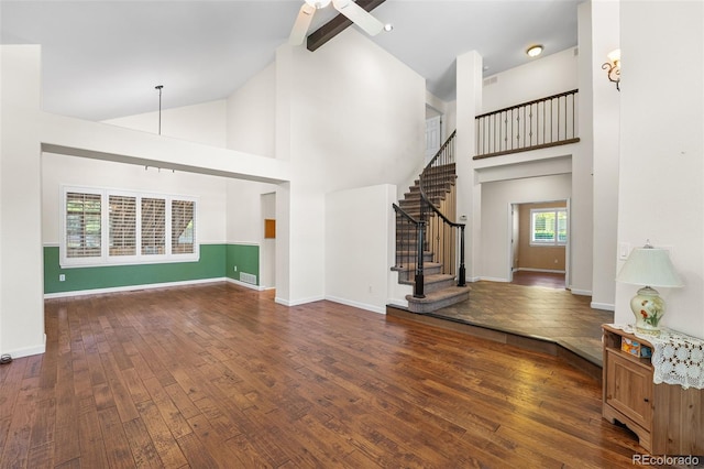 9365 Erminedale Dr, Lone Tree, CO 80124 - unfurnished living room with hardwood / wood-style floors, high vaulted ceiling, stairway, a ceiling fan, and beamed ceiling