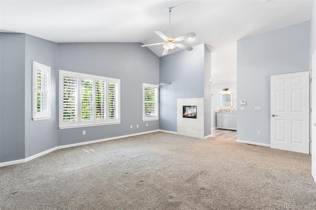 9365 Erminedale Dr, Lone Tree, CO 80124 - unfurnished living room with high vaulted ceiling, carpet, a fireplace, and a ceiling fan
