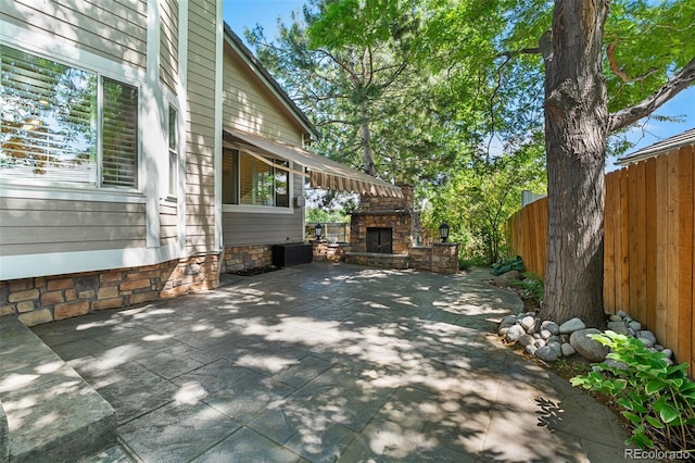9365 Erminedale Dr, Lone Tree, CO 80124 - view of patio / terrace with an outdoor stone fireplace