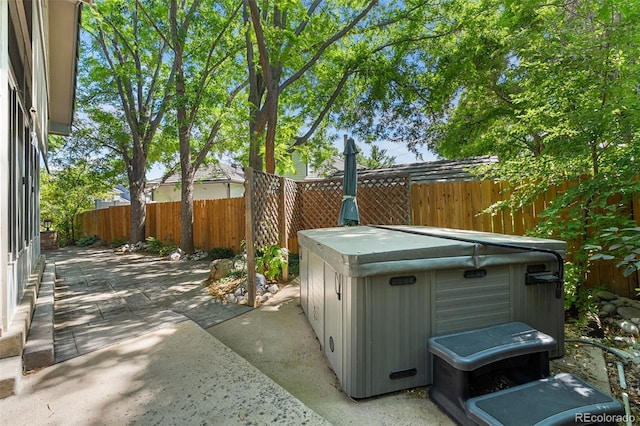 9365 Erminedale Dr, Lone Tree, CO 80124 - fenced backyard with a hot tub and a patio