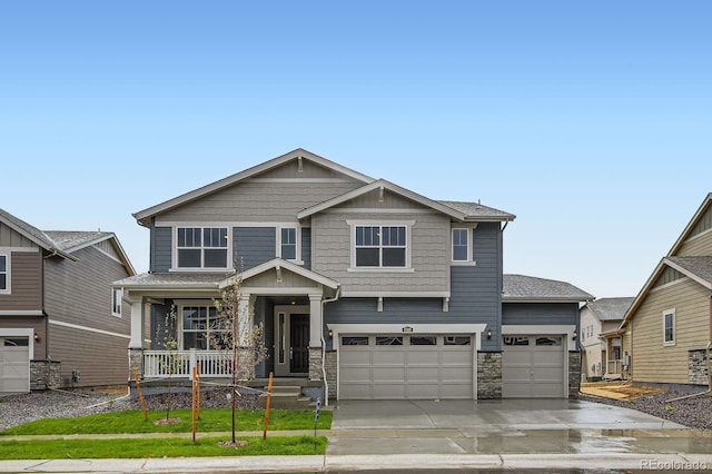 4588 Thistle Dr, Brighton, CO 80601 - craftsman-style home featuring stone siding, concrete driveway, an attached garage, and covered porch