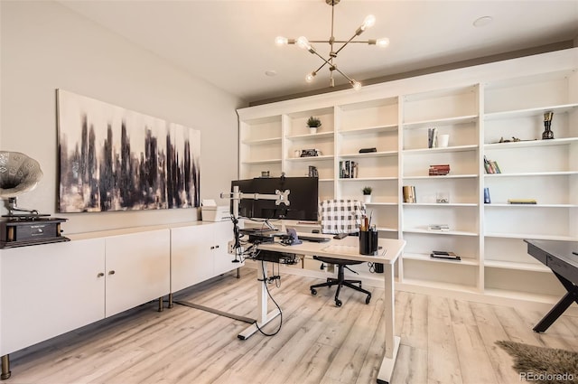 office area with light wood-style flooring and a chandelier