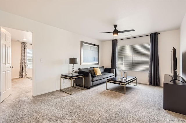 living room with carpet flooring, a ceiling fan, and baseboards
