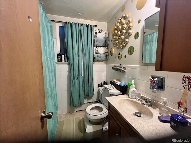 bathroom with a baseboard heating unit, toilet, vanity, tile walls, and a shower with shower curtain